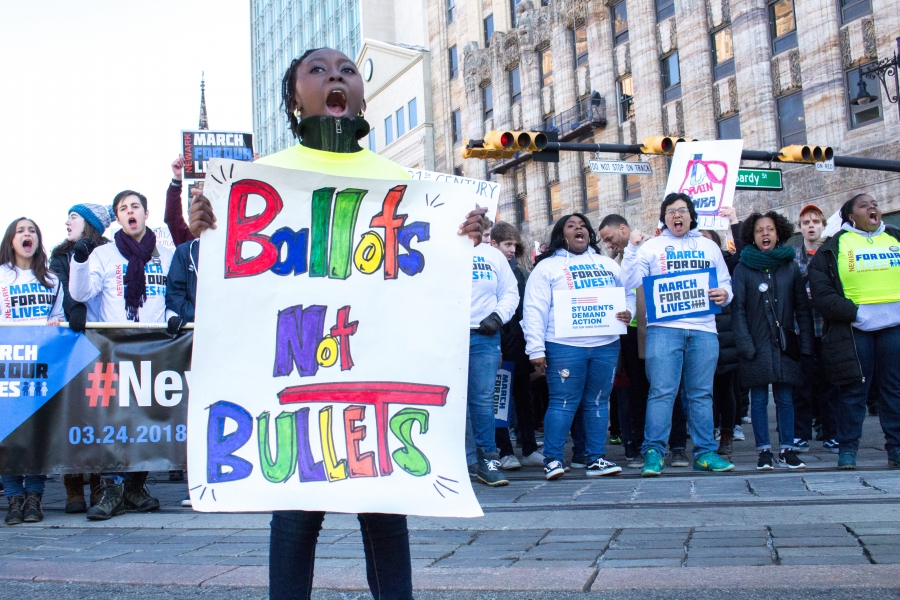 A girl holds a sign in protest at the Newark March For Our Lives.